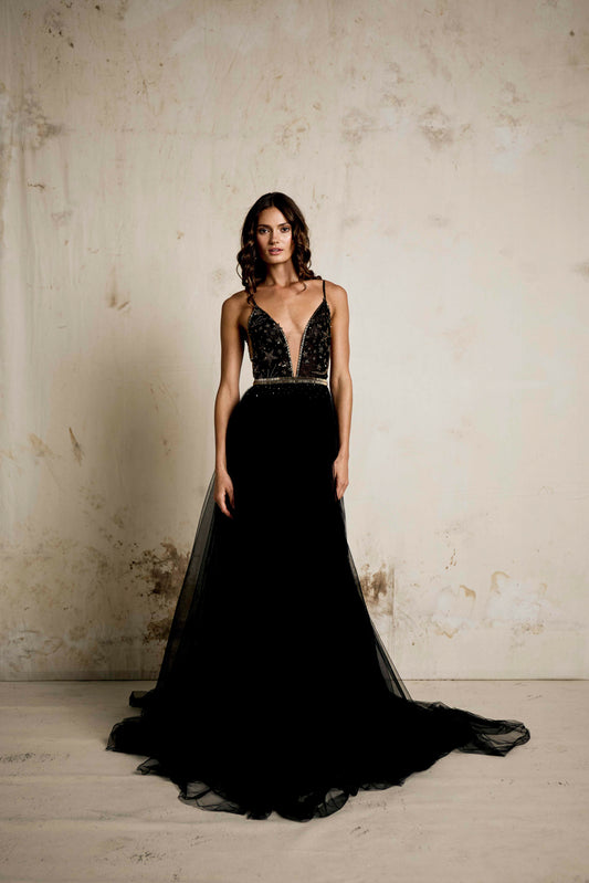 An alternative wedding gown in black with  celestial beaded detailing. V neck dress with star and moon detailing and a full soft tulle skirt with gold detailing and beaded belt.  
