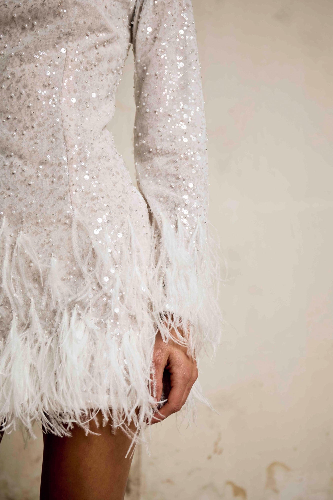 Close-up of sequin sleeve and ostrich feather hemline on Apollo dress, Sadie Bosworth Atelier
